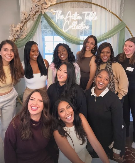 A group of women smiling together at a Root & Rise gathering