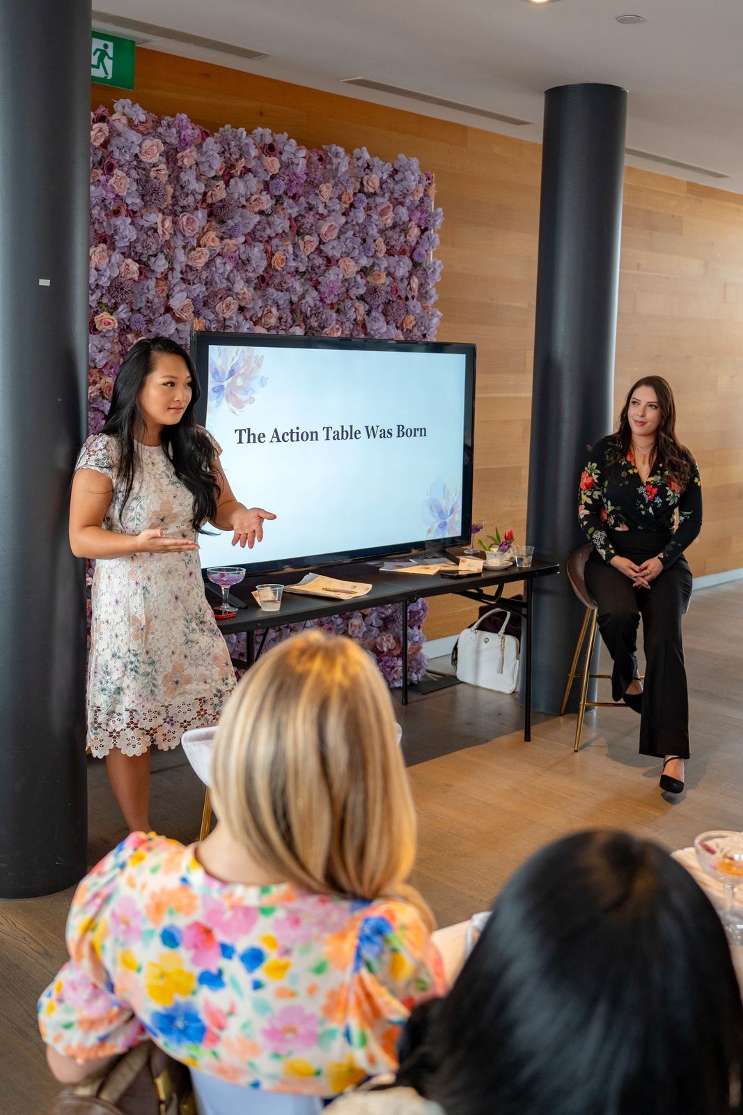 Trisha presenting The Action Table Was Born, with Hala seated beside the screen
