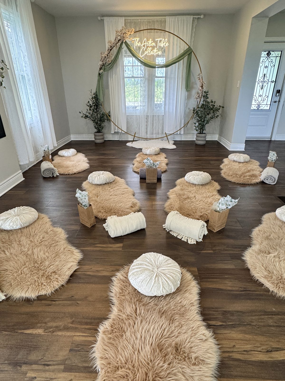 The breathwork room set up with cushions and The Action Table Collective sign