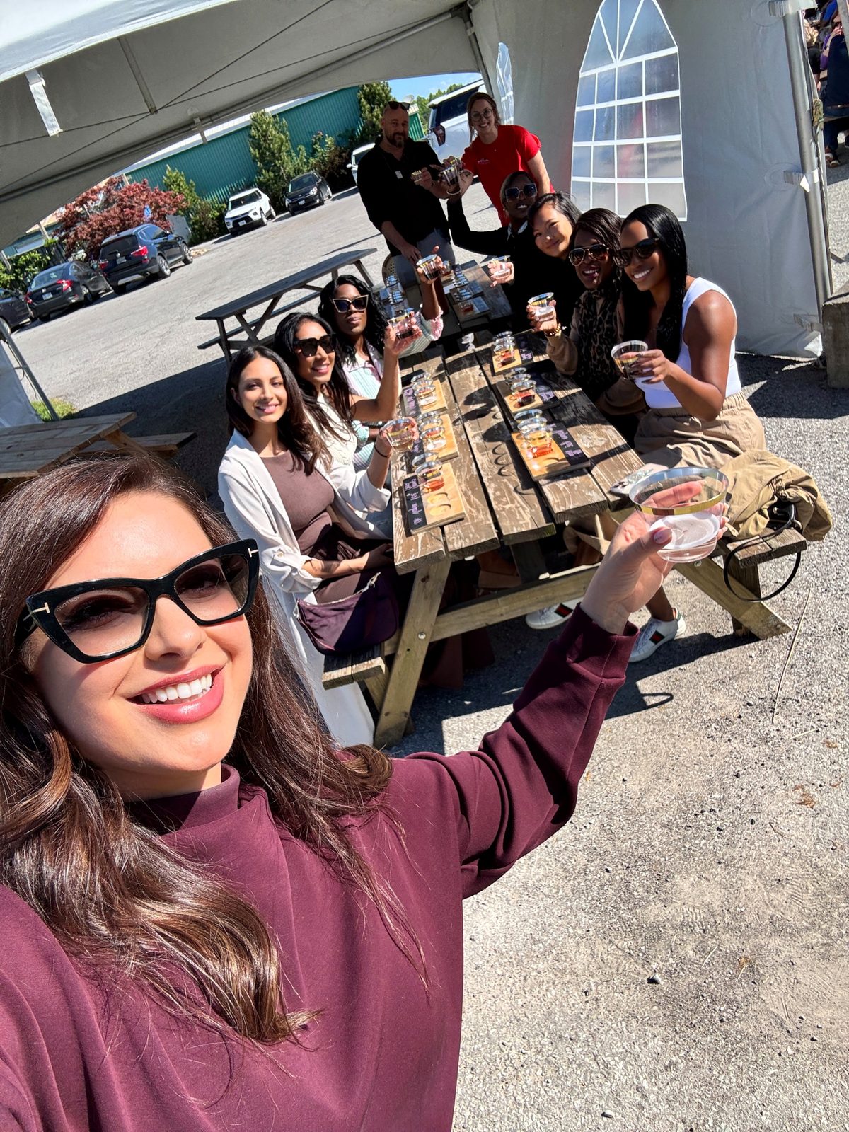 A group toast at an outdoor tasting